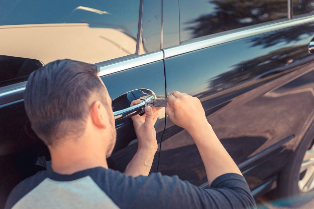 Circle Locksmith Saskatoon technician opening locked car door on Saskatoon street